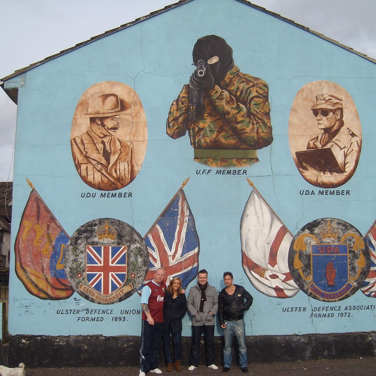 Why should you visit Belfast's famous murals?