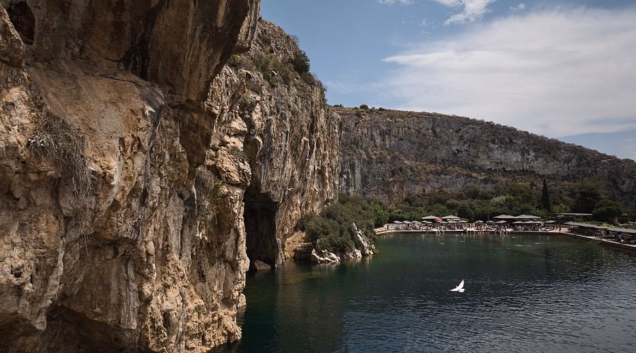 Why should you visit Lake Vouliagmeni?