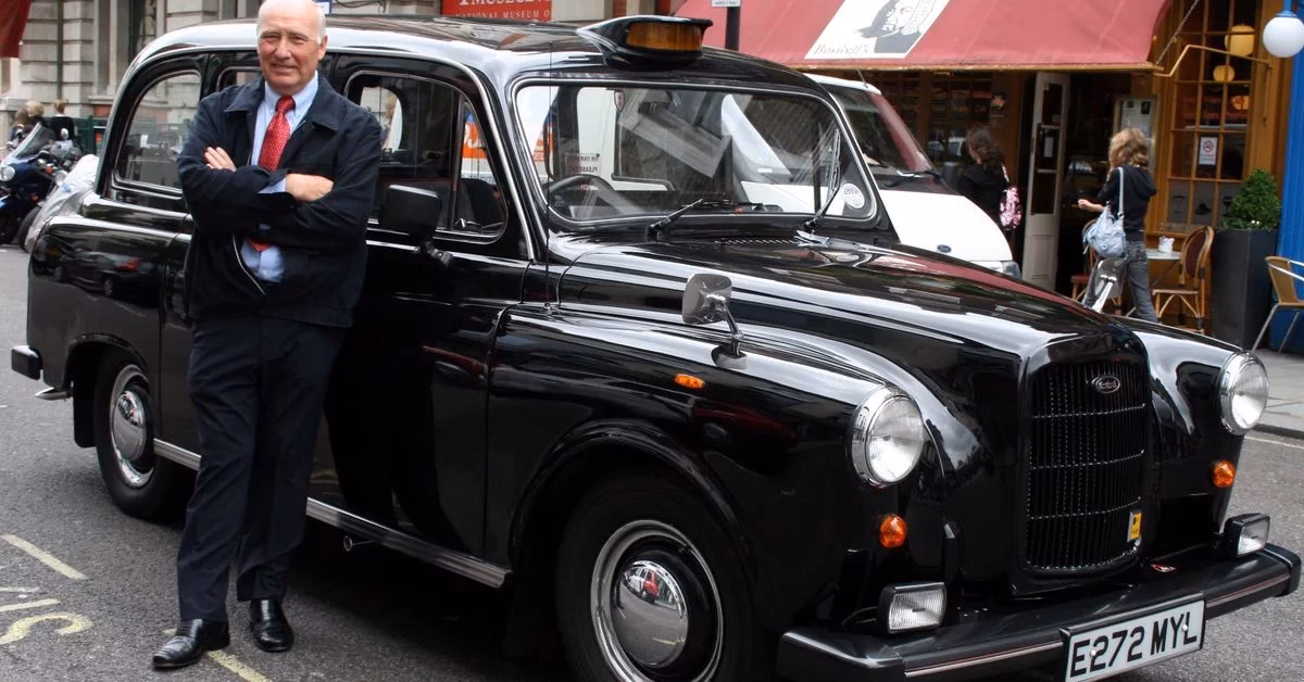 Where is the illuminated TAXI sign on a black cab in London?