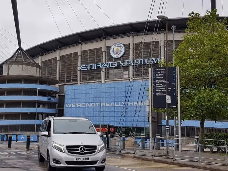 How far is Etihad Stadium from Manchester City Football Club?