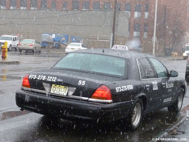 Who offers premium taxi services in Paterson?