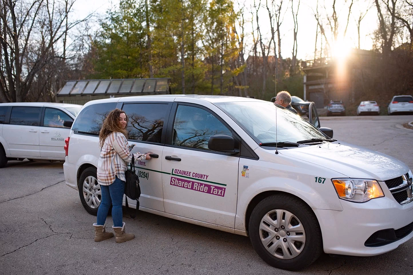 What vehicles does the shared-ride taxi service use?