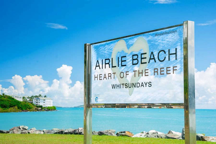 How do I book a transfer from Proserpine to Airlie Beach?