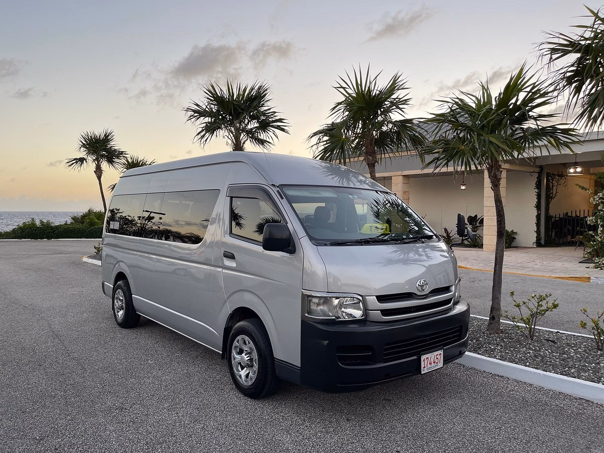 How many passengers can a taxi handle in Grand Cayman?