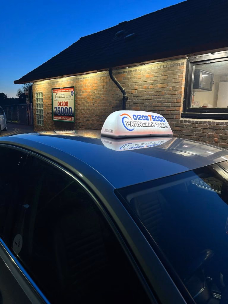 How do I book a taxi from Newquay Airport to Bodmin Parkway?